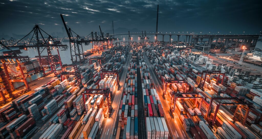 Picture of containers in busy cargo port by night